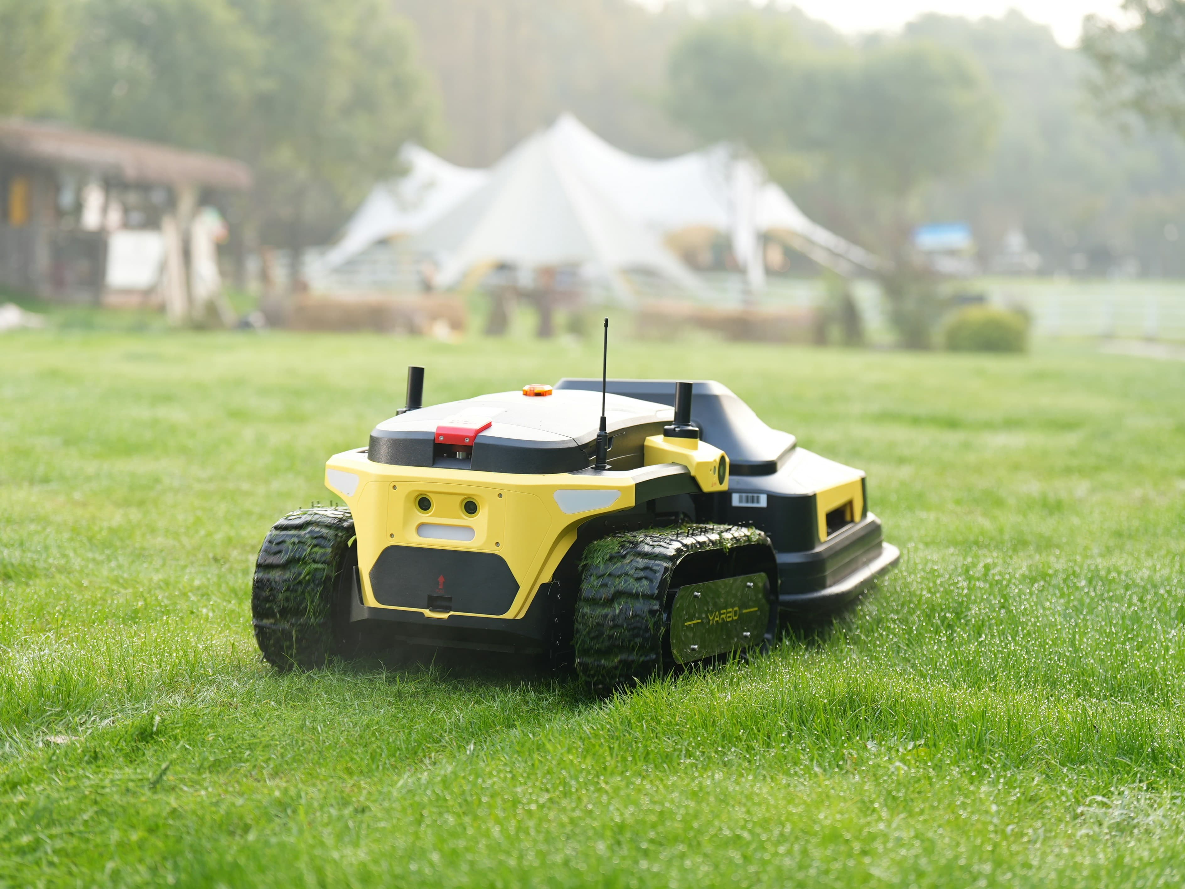 Robotic lawn mower in action on grass field